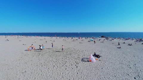 NEW-YORK - AUG 24, 2014: Group of men play soccer on Brighton Beach at summer sunny day. Aerial view. Brighton Beach is sometimes known as Little Odessa.