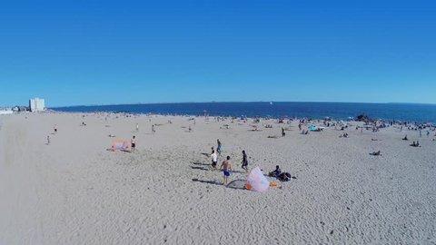 NEW-YORK - AUG 24, 2014: Man scores a goal during play on Brighton Beach at summer sunny day. Aerial view. Brighton Beach is an oceanside neighborhood with population about 76000 people.
