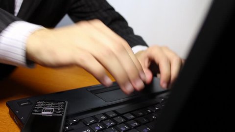 Businessman typing on laptop keyboard