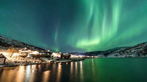 Northern Lights and city lights near Tromsø coast