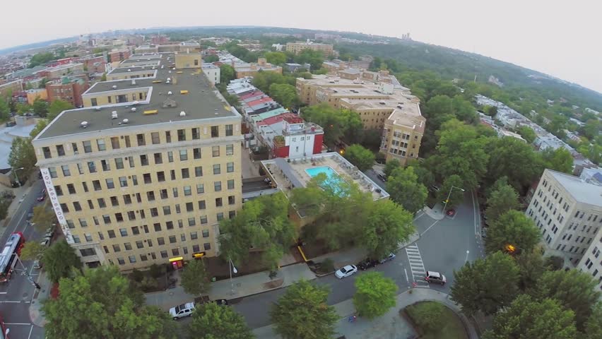 City panorama with traffic on crossroad and neighborhoods Columbia Heights, Adams Morgan and Mount Pleasant at summer evening in Washington DC. Aerial view