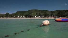 Stock Video Footage 1920x1080 View From The Water To The Shore Banana Buoy Blue Paradise Tropical Summer Breeze Wave Tourists, people relax, fun, sunbathing, swimming, water sports entertainment. 