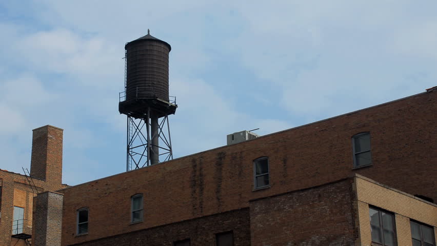 City water tower with clouds time lapse