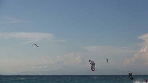 GREECE, LEFKADA, JULY 14, 2014: Kite surfing. Mediterranean island beach, colorful kites, hot summer day.