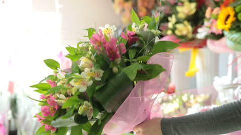 Woman making a flowers bouquet in flower shop