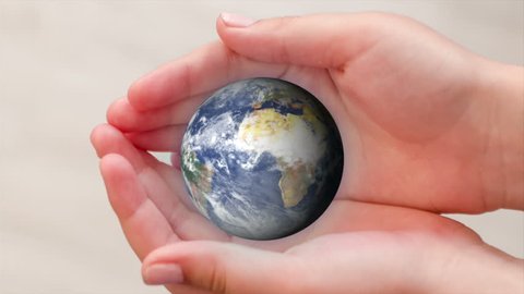 World in human hands, Earth globe rotated in the palms of the child