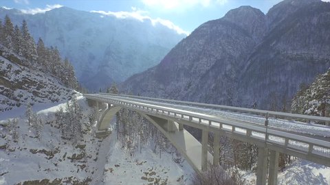 AERIAL: Car drives across mountain viaduct