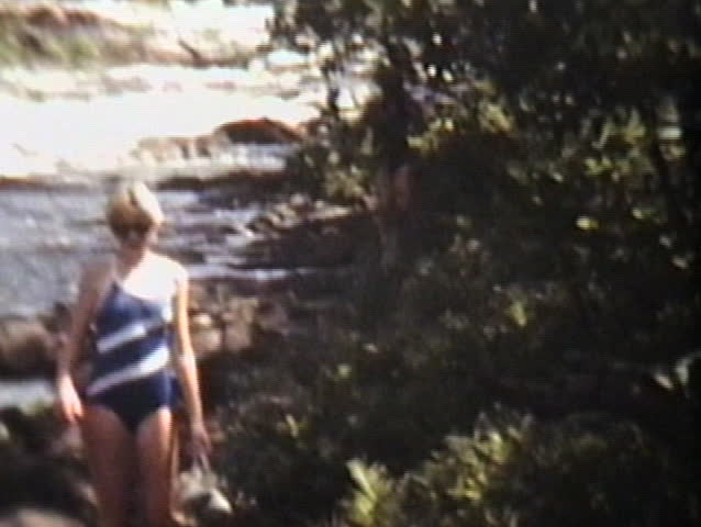 A couple of teenage girls enjoy spending some time shooting the rapids on inner tubes.