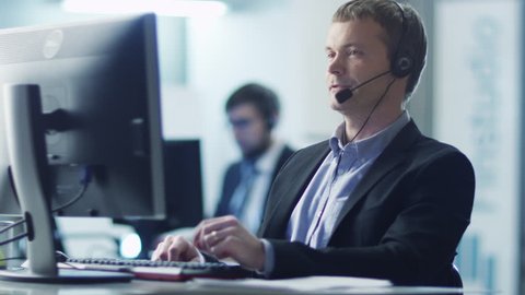 Customer Service Operator at Work in Call Center. Shot on RED Cinema Camera in 4K (UHD). Its easy scale, rotate and crop without loosing quality.
