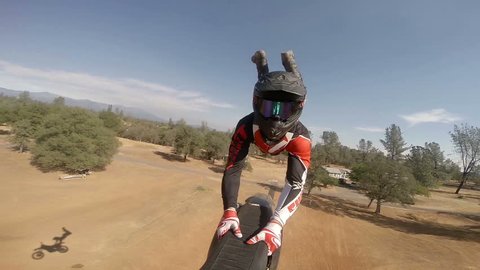 POV action camera shot of motocross rider going off jump