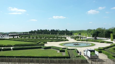 VERSAILLES, FRANCE - CIRCA SEPTEMBER 2014: Gardens of Palace of Versailles, France - with tourists admiring the park and fountains. Versailles is one of the most visited art museum in the world
