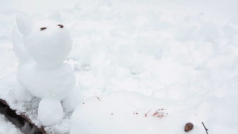 Snowdog sculpture making from snow, winter fun