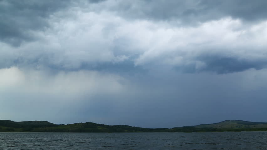 approaching storm - storm clouds over lake
