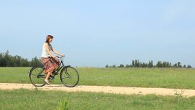 HD video clip of a young girl girl riding a bicycle
