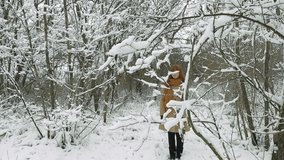 Young Woman Walking in Winter Forest