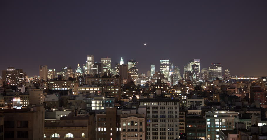 New York City timelapse of skyline at night, lit up with bright lights.  Financial district, city hall in shot. 