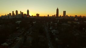 Atlanta Aerial Cityscape Sunset Park v47. Low flying Atlanta aerial over neighborhood, apartments, and park with cityscape sunset view.