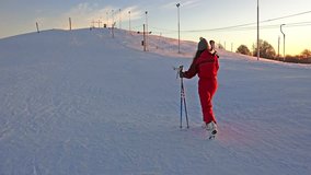 4K Skier climbing a snowy mountain at sunset. UHD steadycam stock video