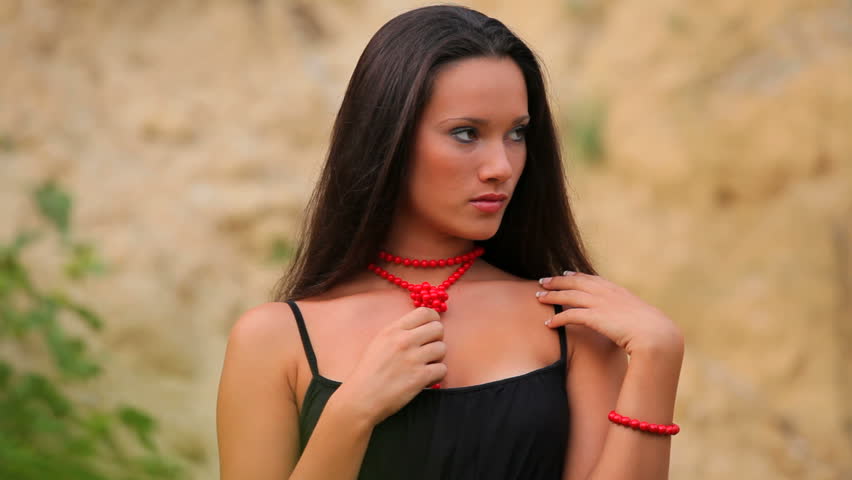 Beautiful girl with a red necklace around her neck.
