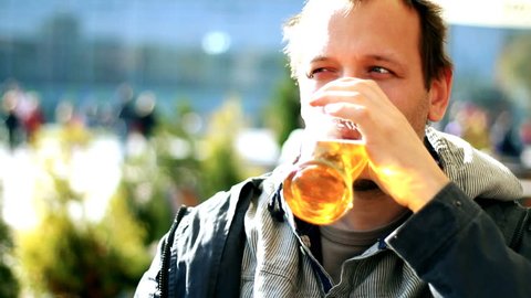 Man drinking beer outdoors,  steady cam shot  Stock Video