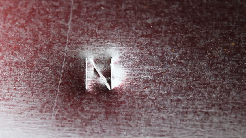 A metal sheet is stamped with the word NO