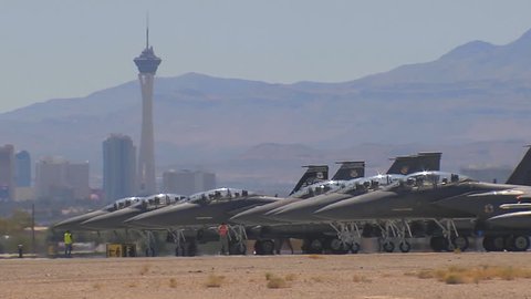CIRCA 2010s - Numerous F-15 and F-16 fighter jets line up and taxi for takeoff in a military exercise.