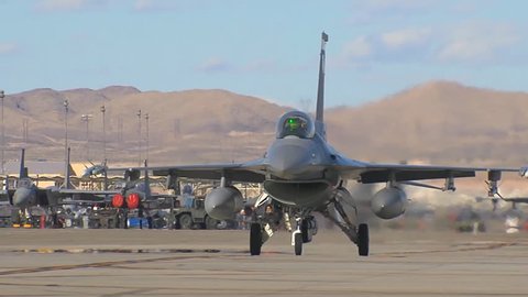 CIRCA 2010s - F-15 and F-16 fighter jets line up and taxi for takeoff in a military exercise.