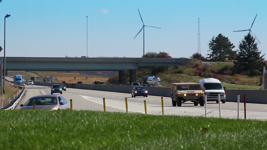 Traffic passes by tall wind turbines by the Pennsylvania Turnpike in Somerset