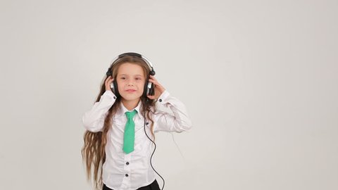 Small Cute Girl Listening to Music With Headphones And Dancing