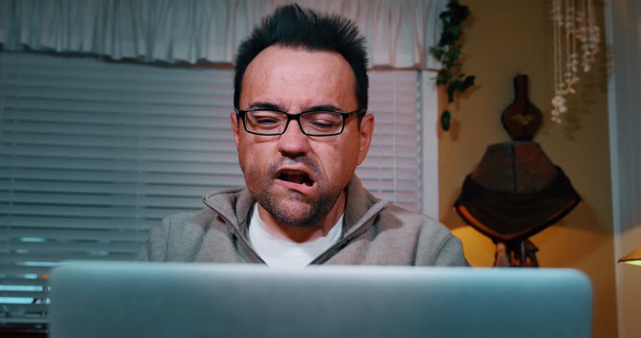 A man is blown away by the speed of his Internet connection. | Shutterstock HD Video #9093896
