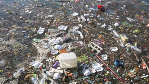 Plastic bottles and other trash floating in ocean 