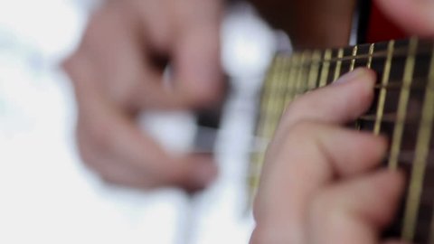 Guitar playing, close up video on white background