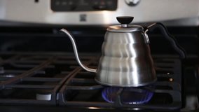 Clip of a tea kettle boiling on the stove with rattling sound