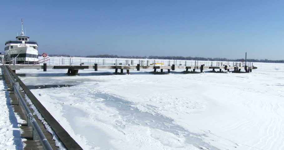 Boat docked in Toronto, Canada, on the frozen waters of lake Ontario
