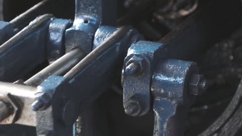 Close shot of a steam powered engine piston in motion.