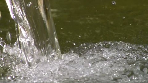 Water splashing on a fountain, droplets of water closeup