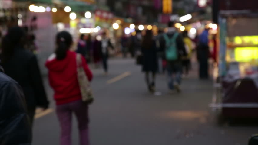 NEW TAIPEI CITY, TAIWAN - MARCH 7, 2015: Vendors and shoppers at Lehua Night Market in the Yonghe District, defocused
