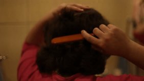 Woman combing her hair. HD video
