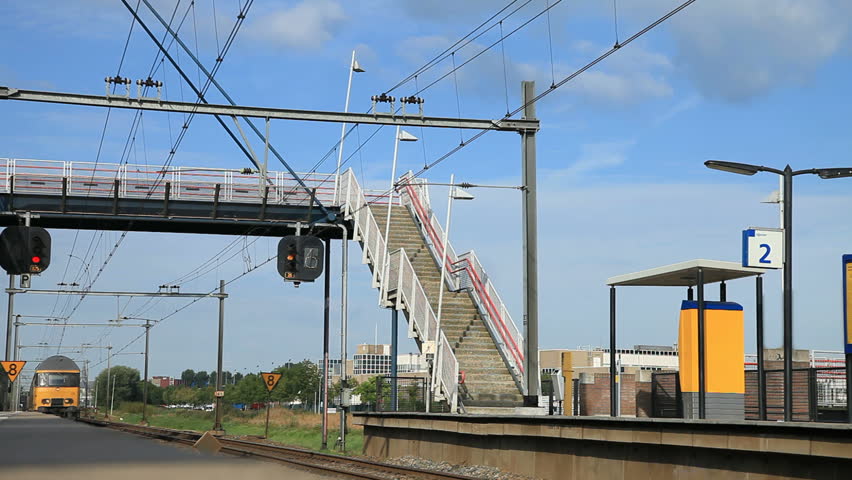 Two train riding along railroad platform in station 