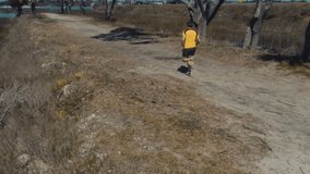 Aerial of Runner on a nature path next to a bay with boats in the background
Stock video clip