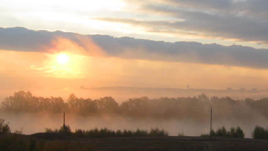 rural mist landscape with sunrise over lake