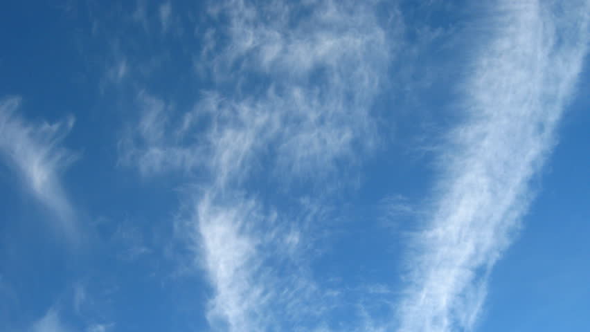 blue sky with fleecy moving clouds in background 