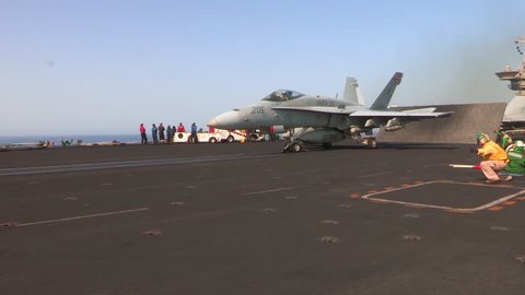 CIRCA 2010s - Various jet aircraft take off from the deck of an aircraft carrier.