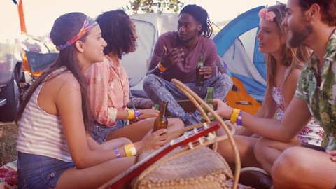 In high quality format multi-ethnic hipsters having fun in their campsite at a music festival