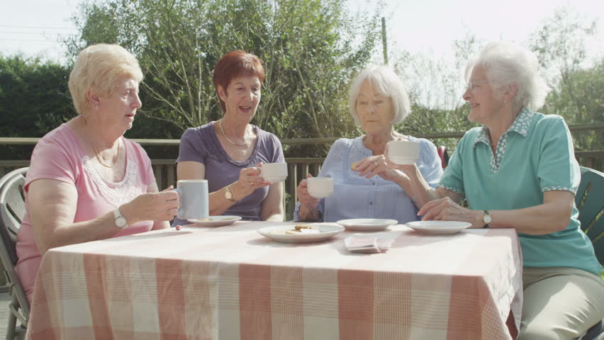 4K Happy female senior friends chatting and laughing together outdoors with cups of tea | Shutterstock HD Video #9148109