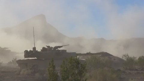 CIRCA 2010s - U.S. army tanks fire in the desert.