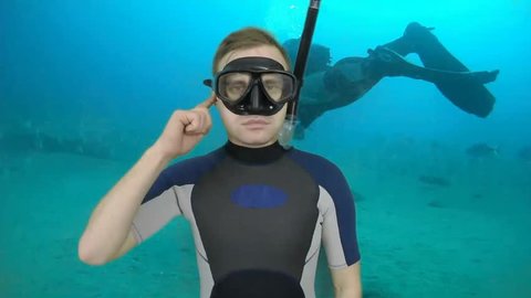 Diving sign- divemaster  shows sing  TROUBLE WITH EAR,  I CAN NOT EQUALIZE PRESSURE   ,also a available on the green screen all of diving sings from course (open water diver) 1 0F 3