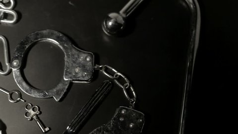 BDSM tools on black table