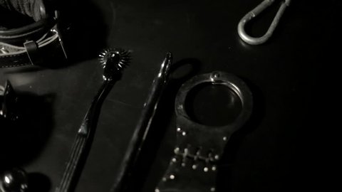 BDSM tools on black table