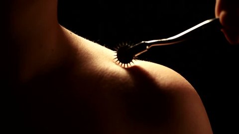 master passes through the body of a young submissive girl using Wartenberg wheel bdsm theme